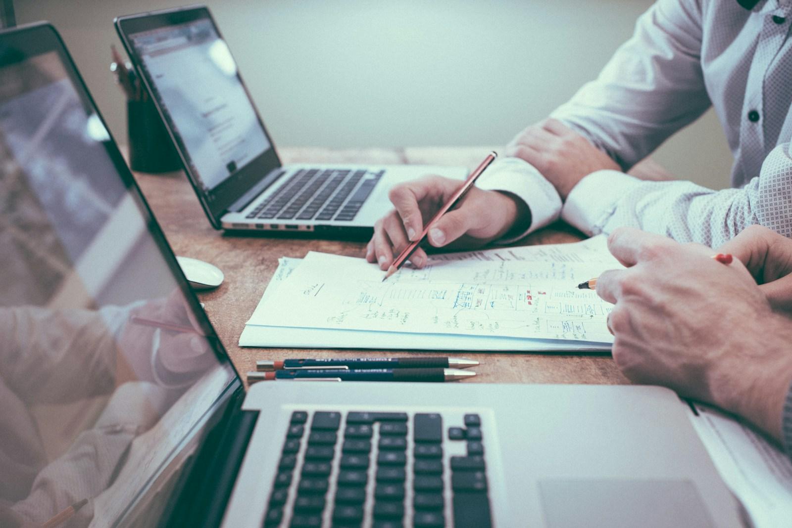 Finance professionals reviewing financial reports and charts together