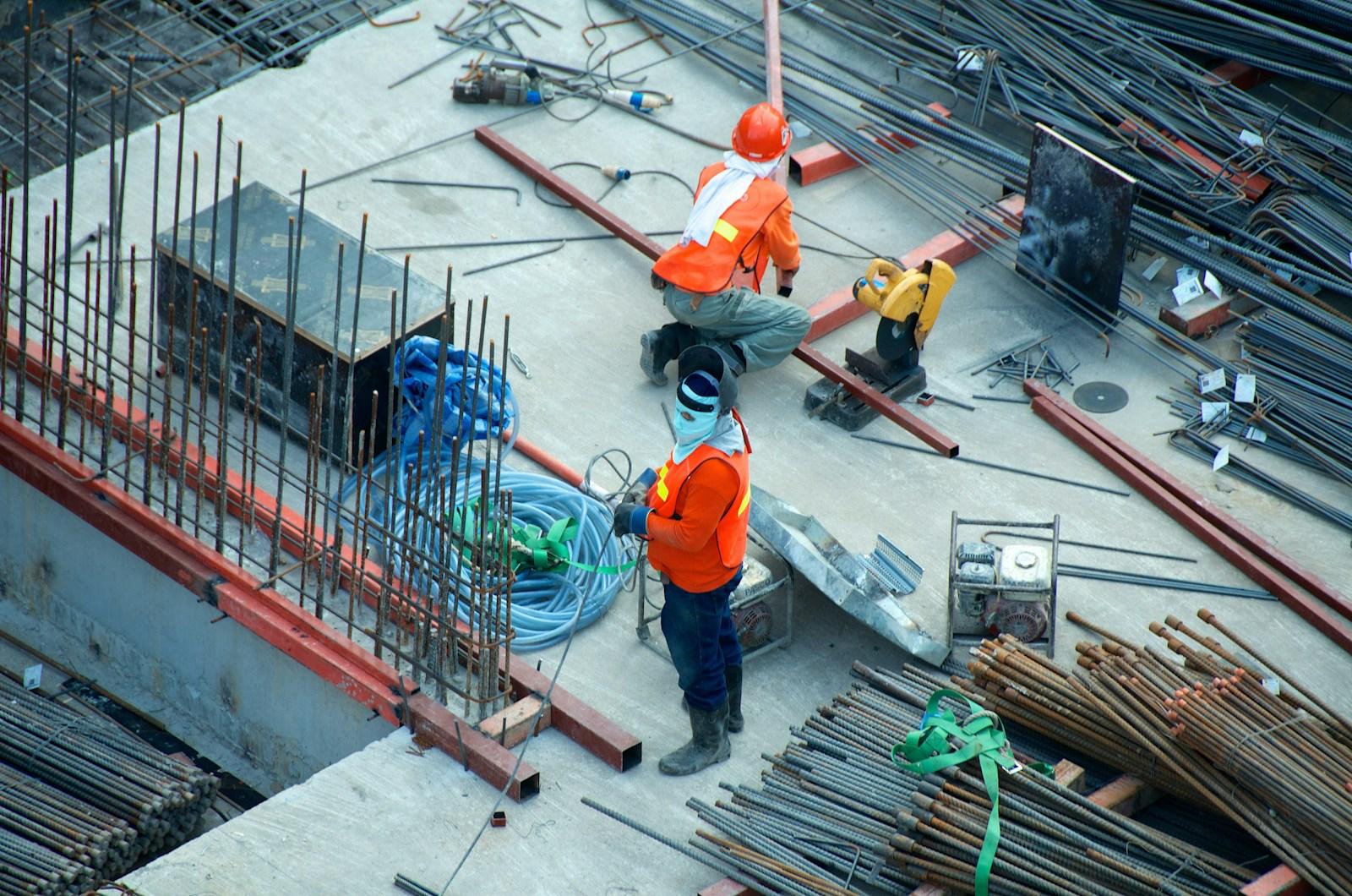 Construction professionals in safety equipment working on a building site